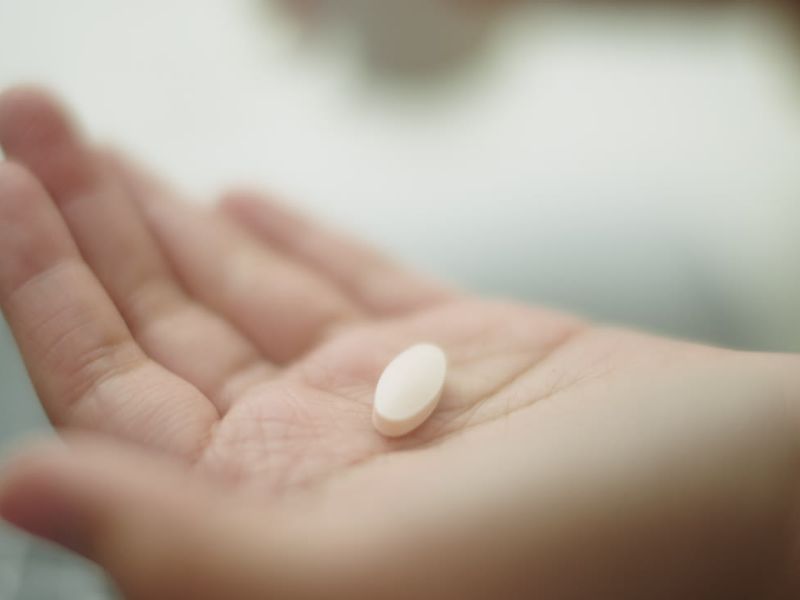 osoba stavlja lek na dlan