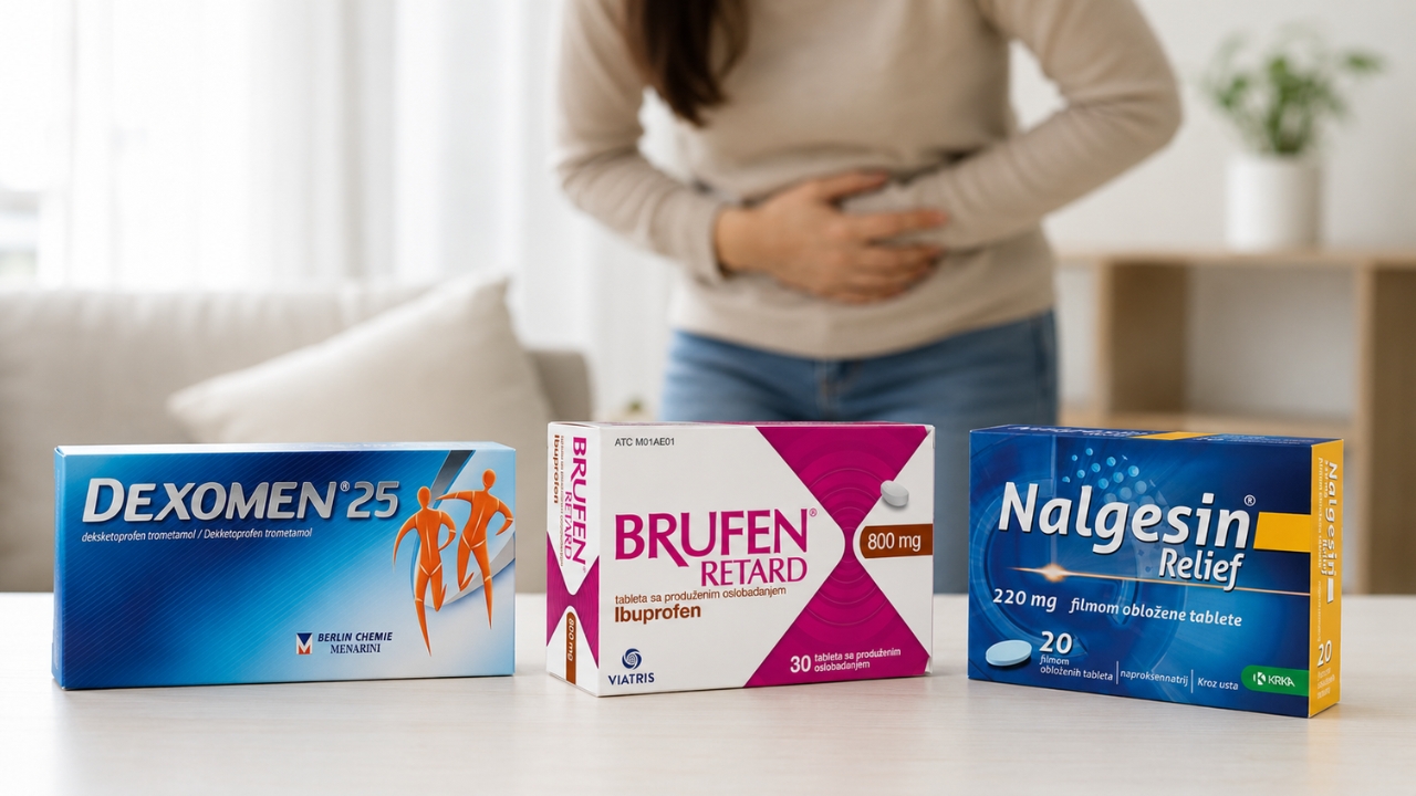 Kutije lekova Dexomen, Brufen i Nalgesin stoje na stolu dok se osoba u pozadini drži za stomak