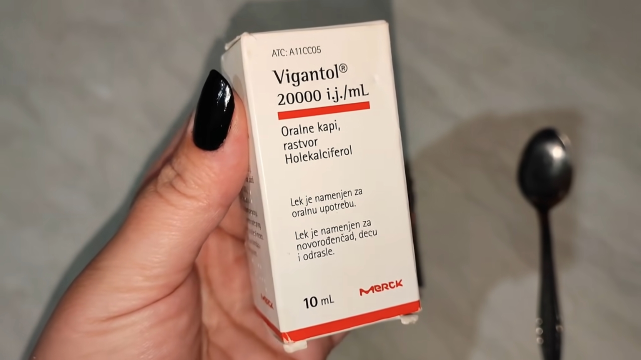 Pakovanje Vigantol kapi u ruci pored kašičice